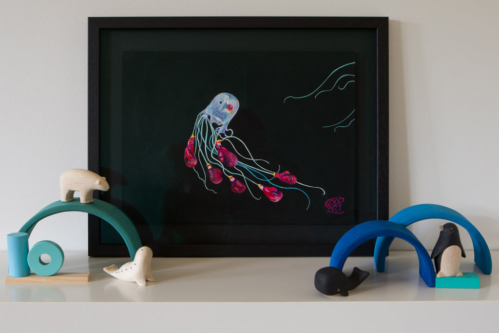 An artwork of a Box Jellyfish wearing boxing gloves with a somber face and black eye. Another jellyfish is swimming out of the composition. Black background. Wall Art for boys bedroom Painted by artist Jaelle Pedroli.