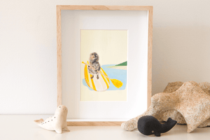 An original painting of a Rottnest quokka blissfully paddling a yellow stand up paddle board over the ocean. Frames original artwork sitting on a shelf.