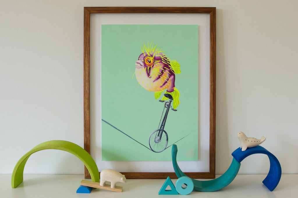 An artwork of a pufferfish riding a unicycle on a tightrope with a predominately green background. A colourful animal print styled with wooden toys in a kids bedroom. Created by Good Art.